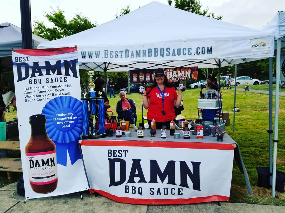 booth at event with award for best bbq sauce