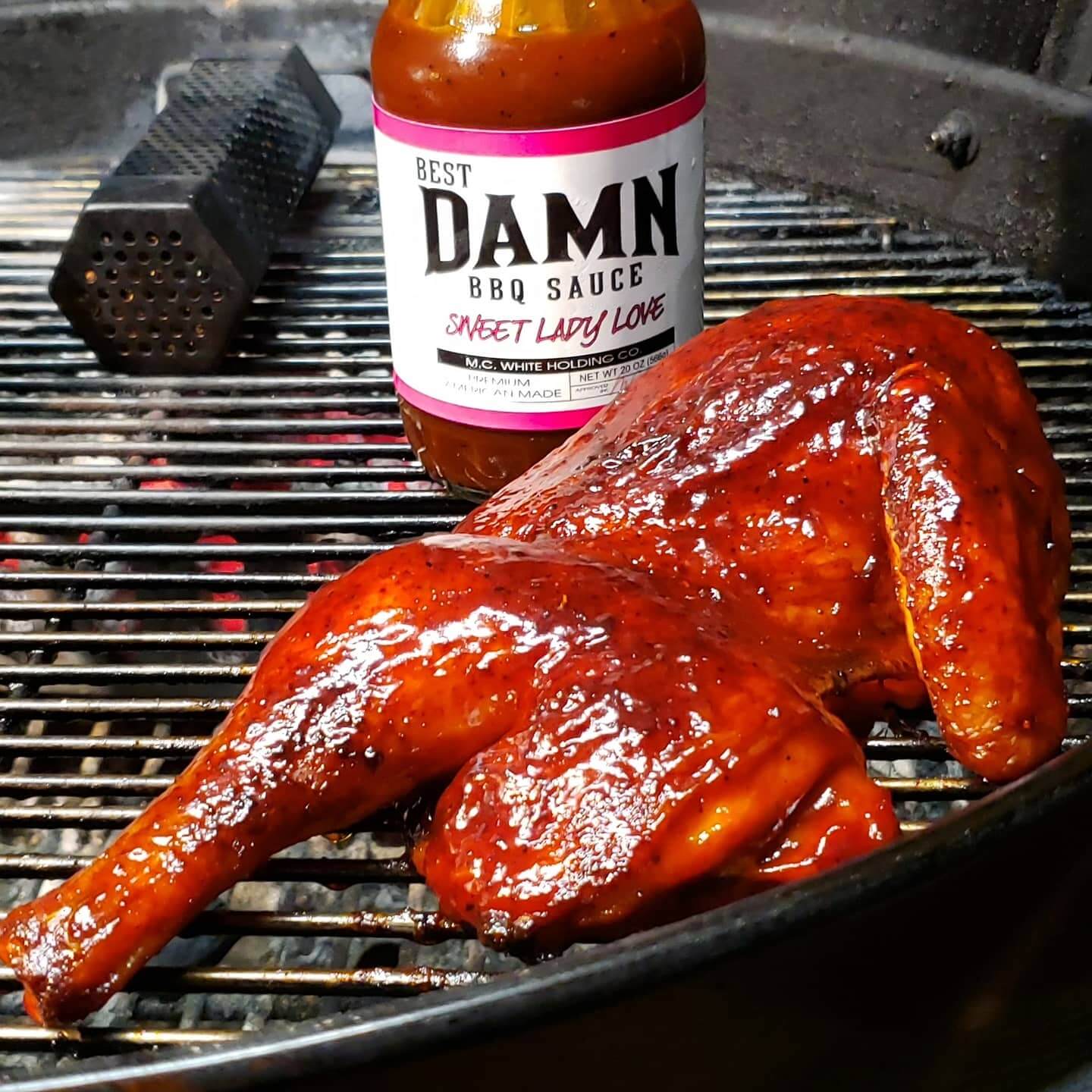 closeup grill chicken with best damn bbq sauce bottle